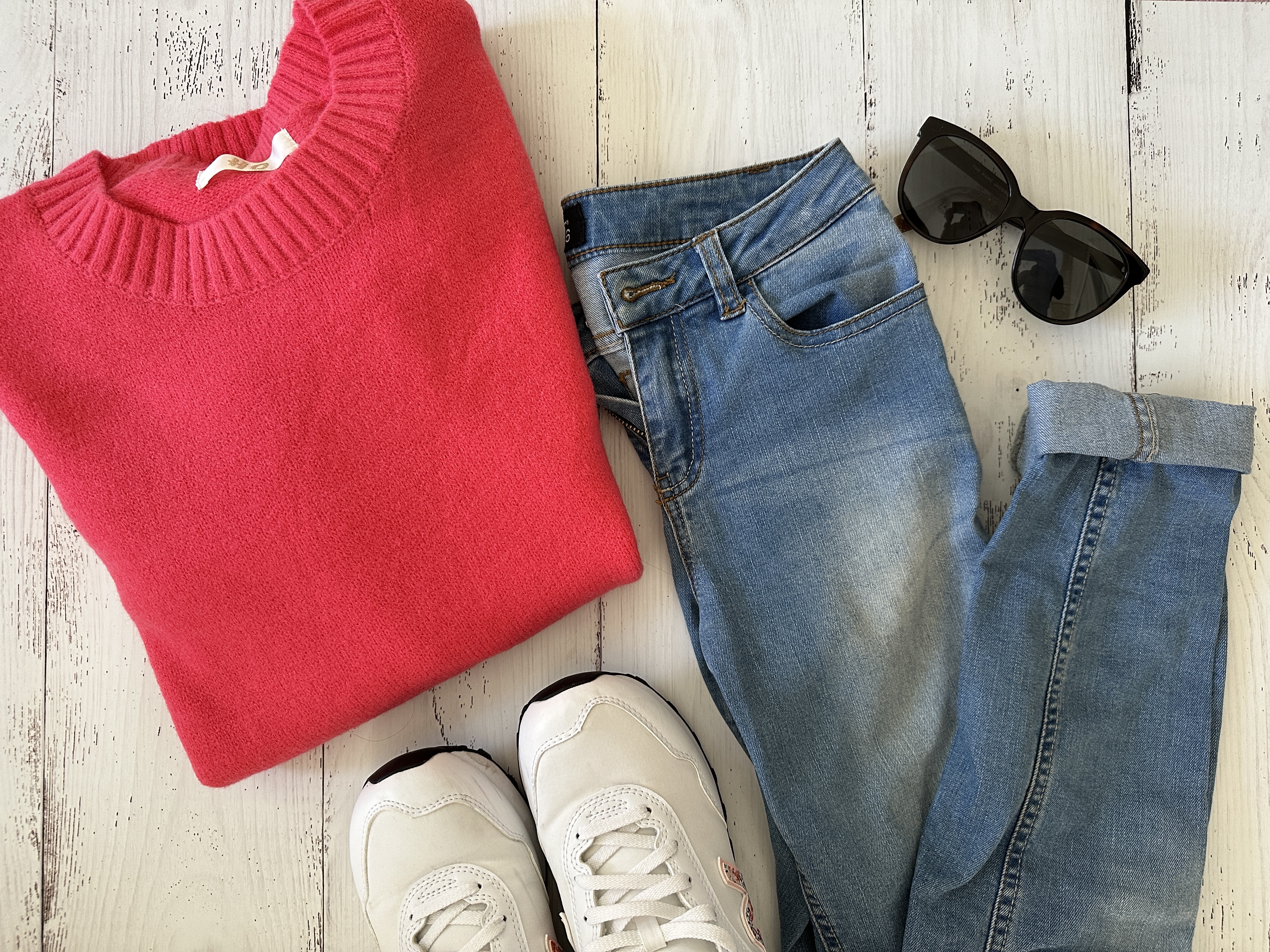 fashion blogger flatlay with pink sweater and jeans