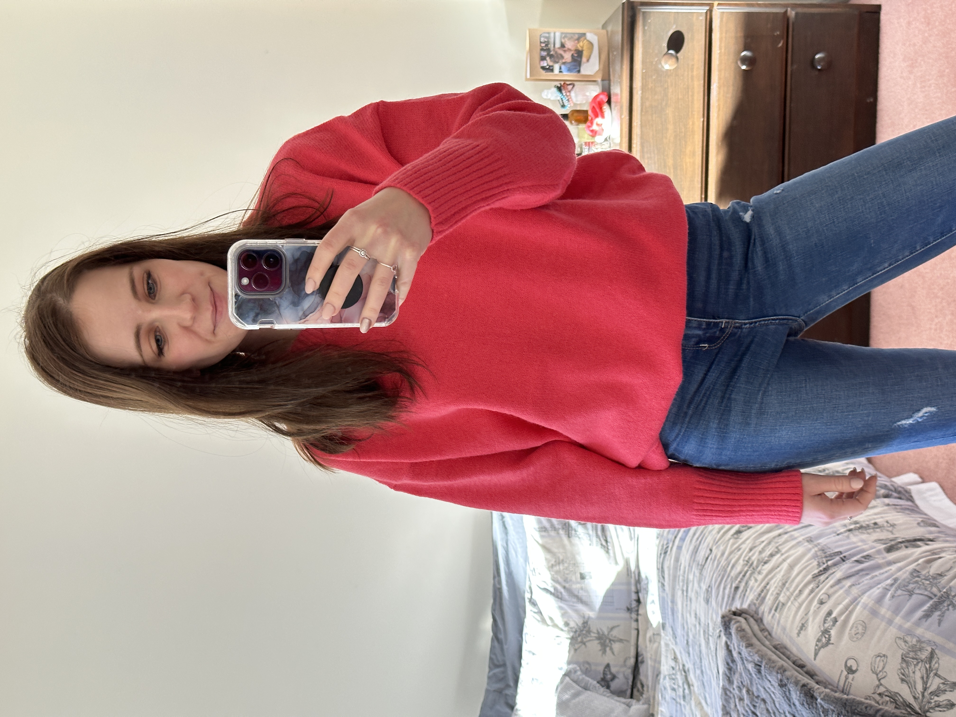 fashion blogger taking mirror selfie with a hot pink jumper