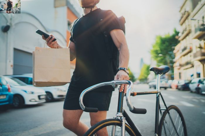 Gig economy worker earning money by delivering food on a bicycle.