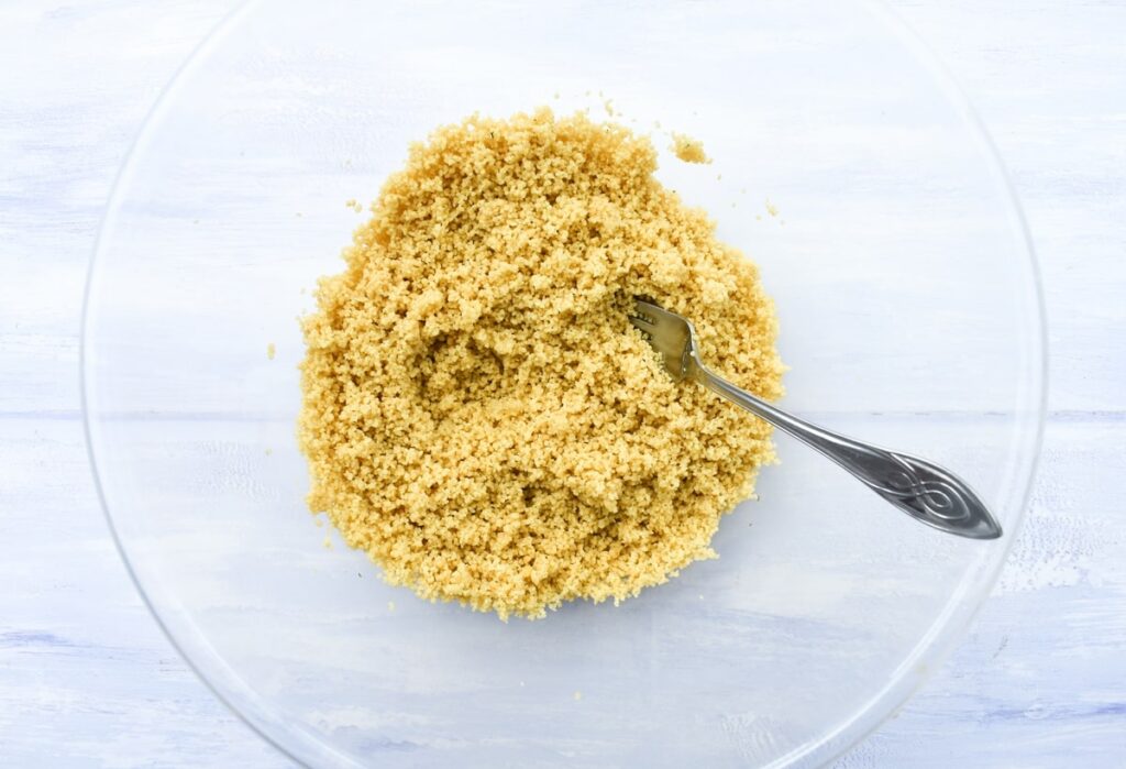 Freshly made couscous, fluffed up with a fork.